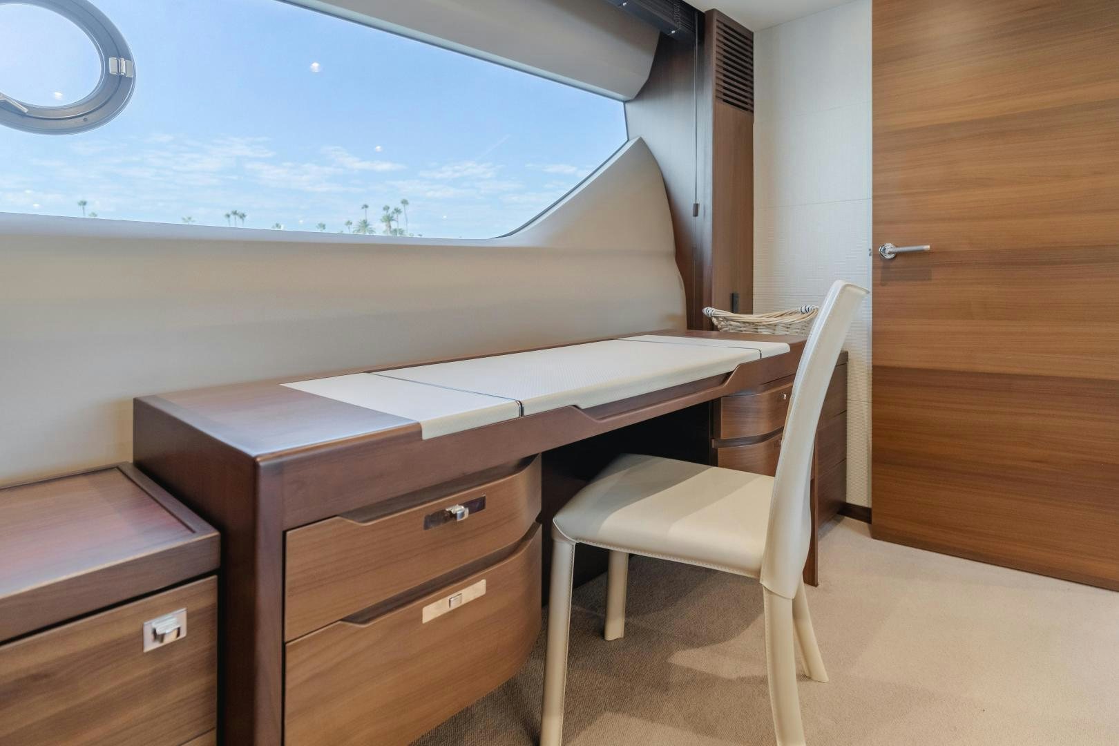 a desk with a chair and a window aboard SEXSEA Yacht for Sale