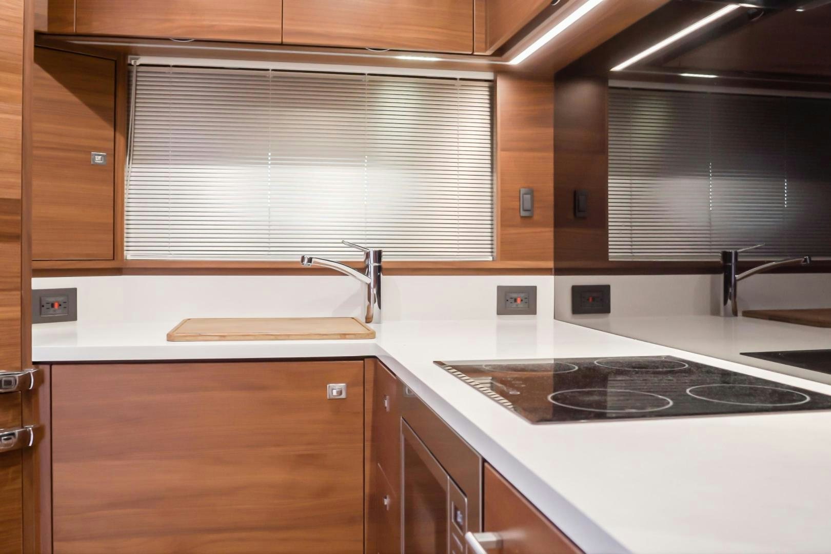 a kitchen with a stove and a sink aboard SEXSEA Yacht for Sale
