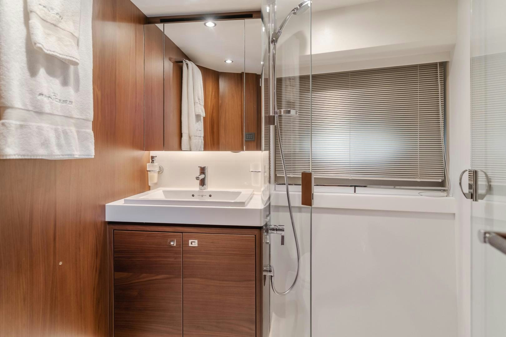a bathroom with a sink and a mirror aboard SEXSEA Yacht for Sale