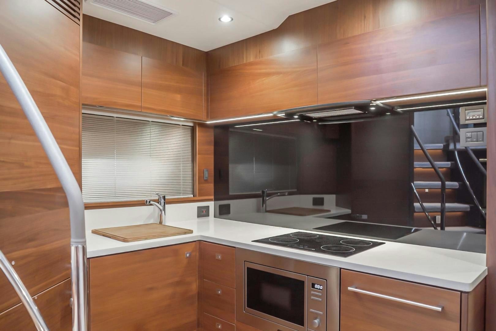 a kitchen with wooden cabinets aboard SEXSEA Yacht for Sale