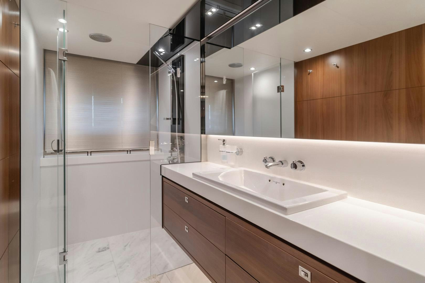a bathroom with a large mirror aboard SEXSEA Yacht for Sale