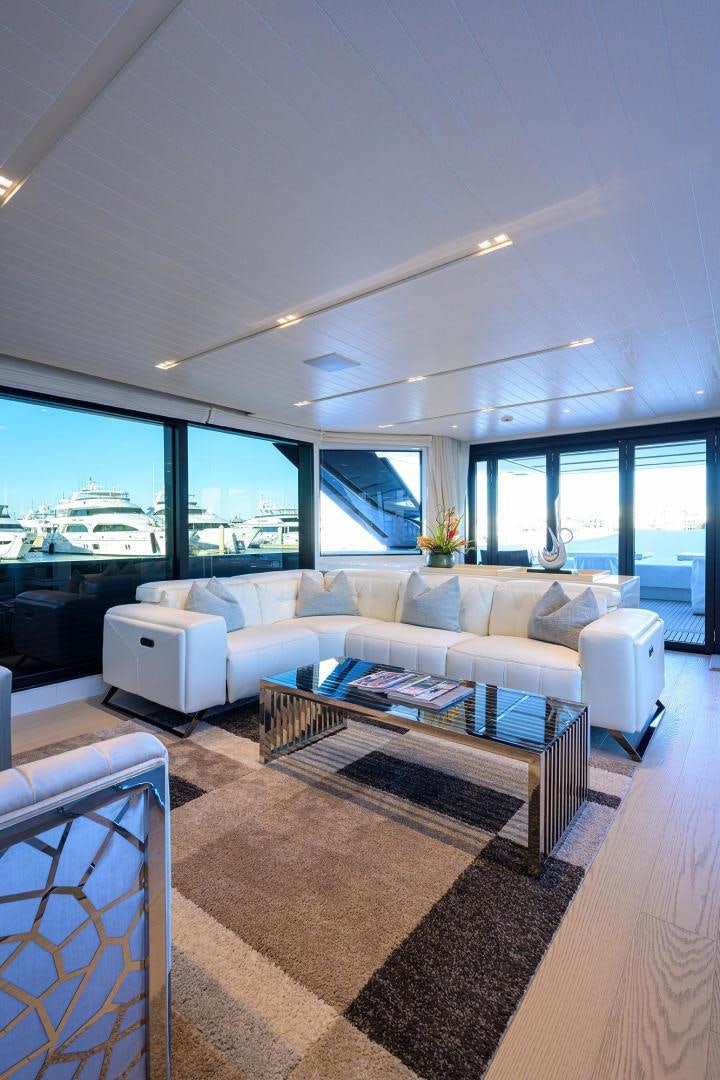 a living room with a couch and a coffee table aboard OUR ALEPH Yacht for Sale