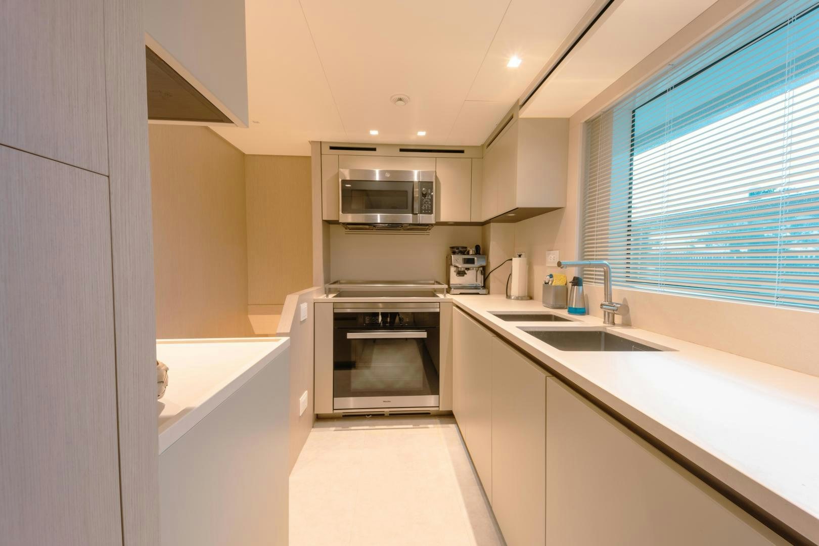 a kitchen with white cabinets aboard OUR ALEPH Yacht for Sale