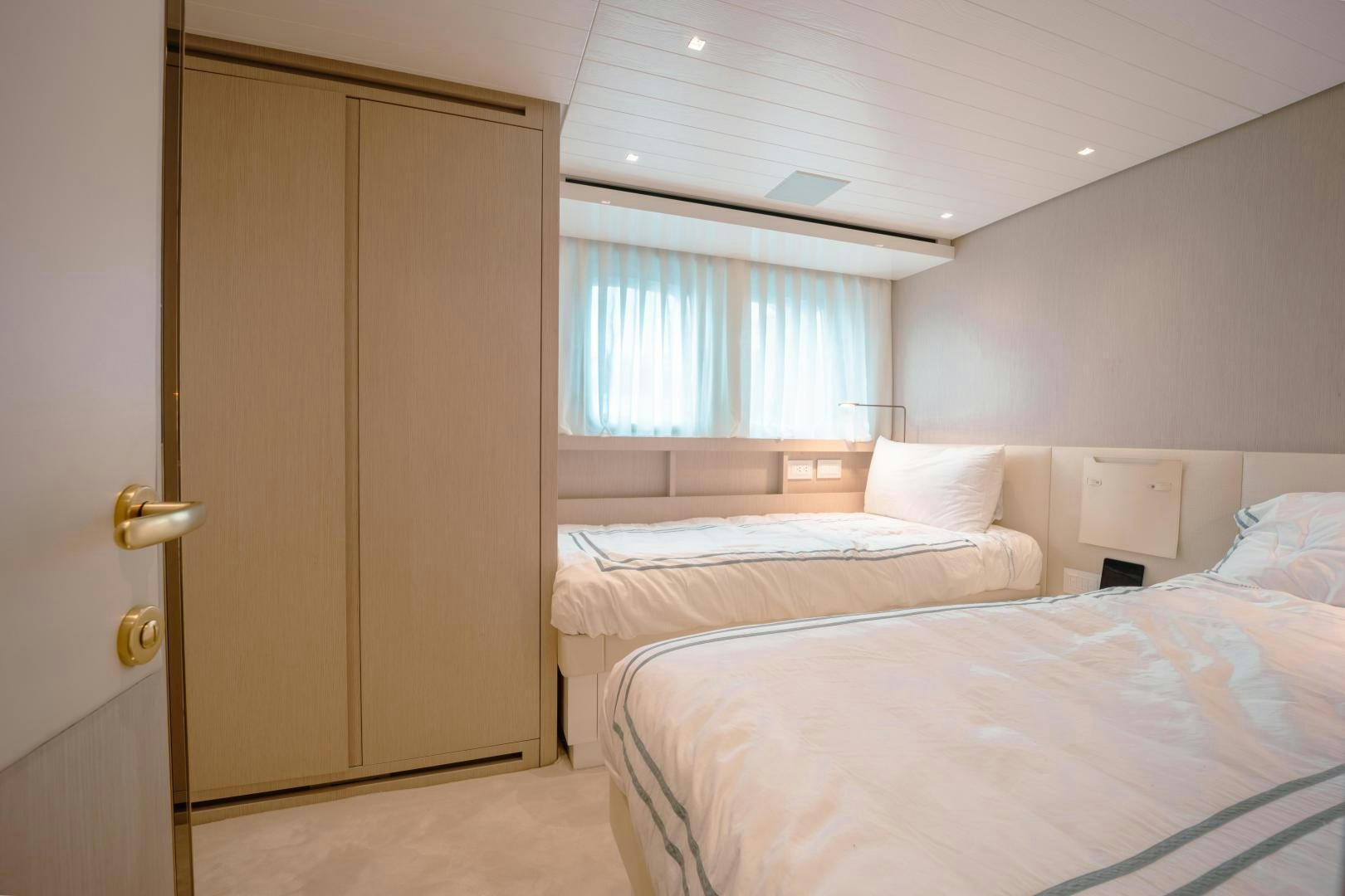 a room with a bed and a door aboard OUR ALEPH Yacht for Sale