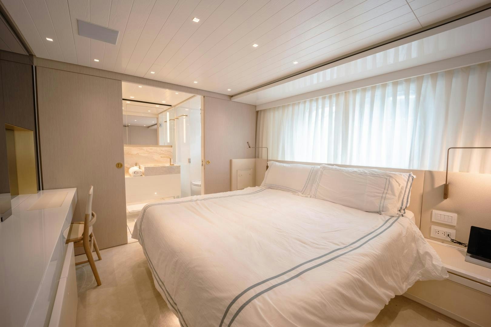 a room with a bed and a desk aboard OUR ALEPH Yacht for Sale