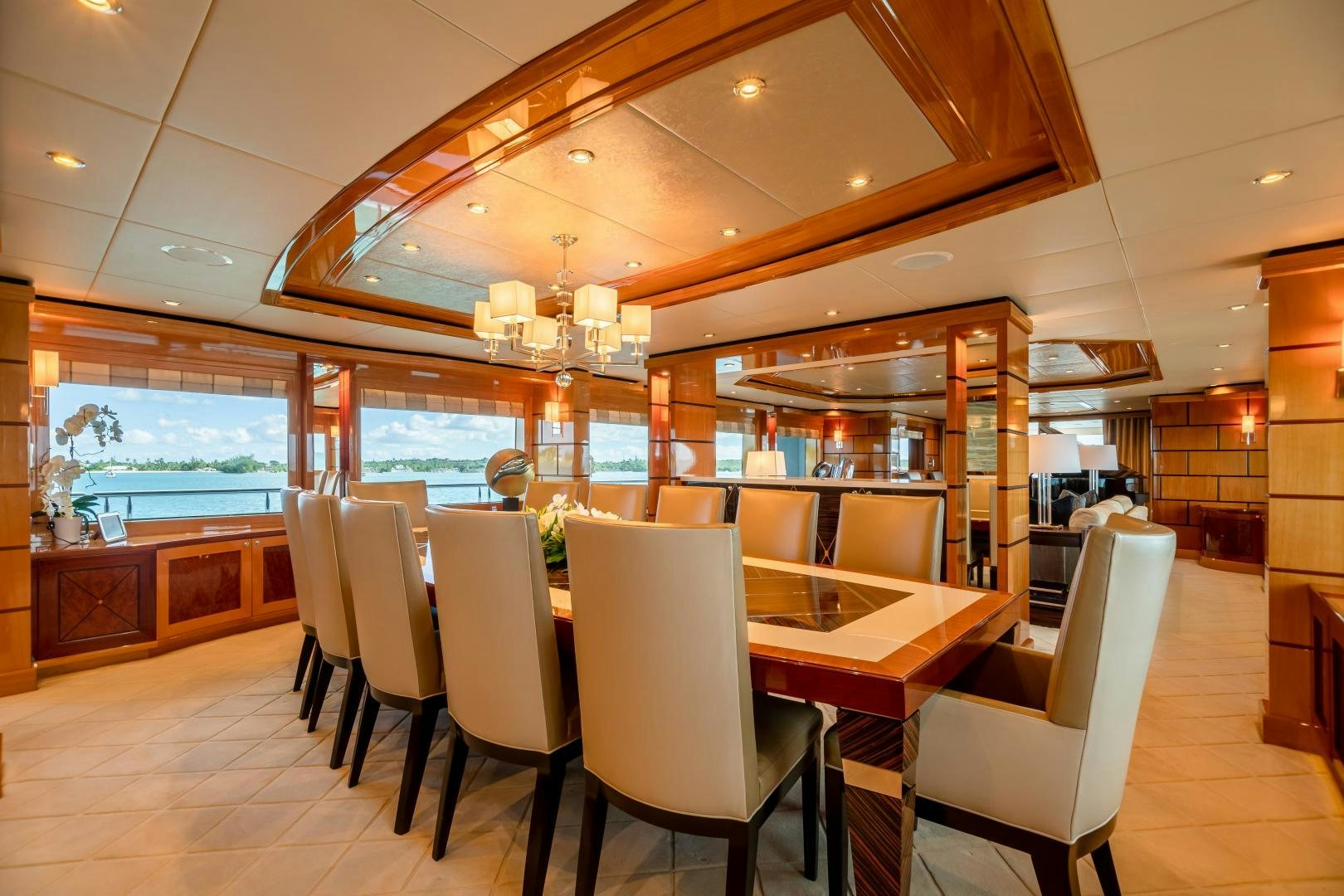 a restaurant with a large table and chairs aboard IMPROMPTU Yacht for Sale