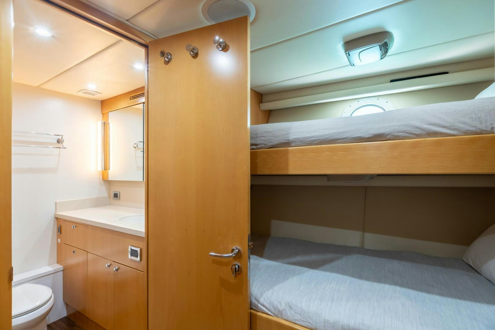a bathroom with a bed and a sink aboard IMPROMPTU Yacht for Sale