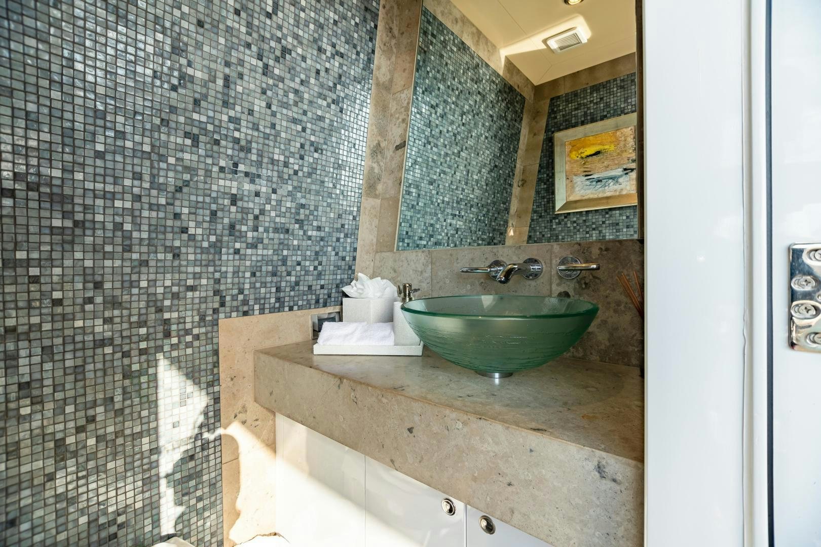 a bathroom with a sink and a tile wall aboard IMPROMPTU Yacht for Sale