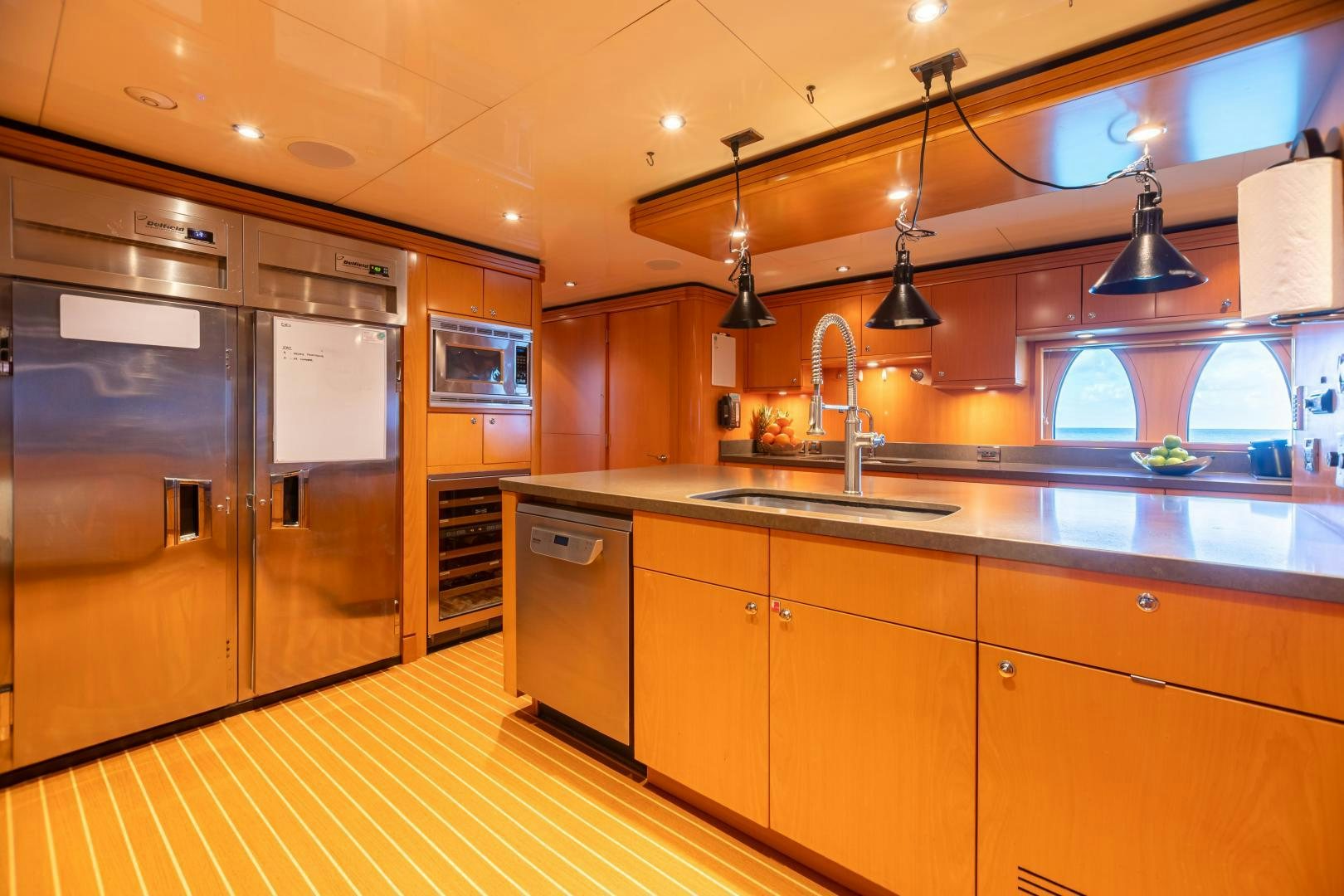 a kitchen with a large island aboard IMPROMPTU Yacht for Sale