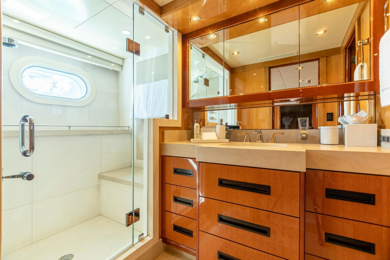 a bathroom with a glass shower aboard IMPROMPTU Yacht for Sale