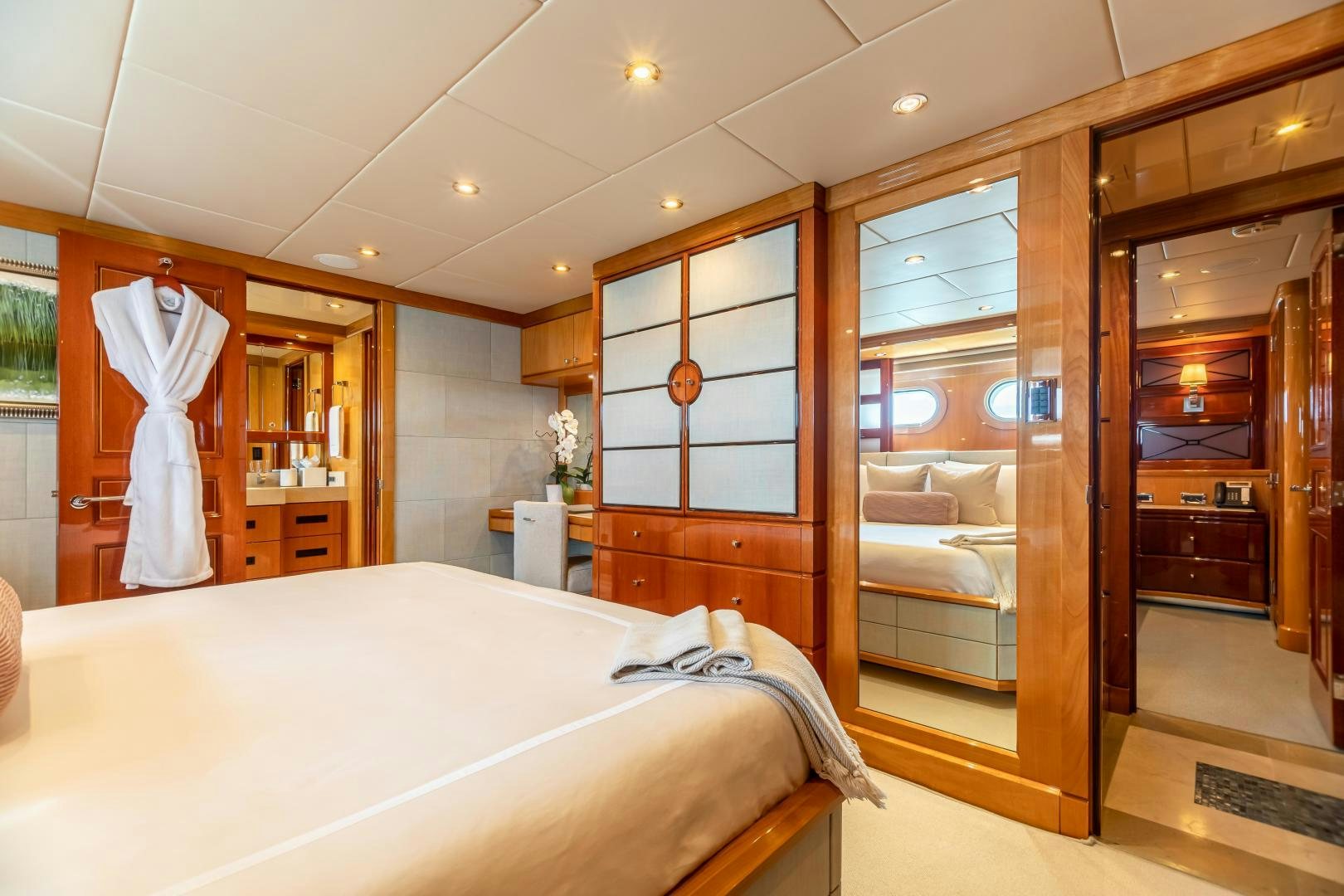 a bedroom with a large mirror aboard IMPROMPTU Yacht for Sale