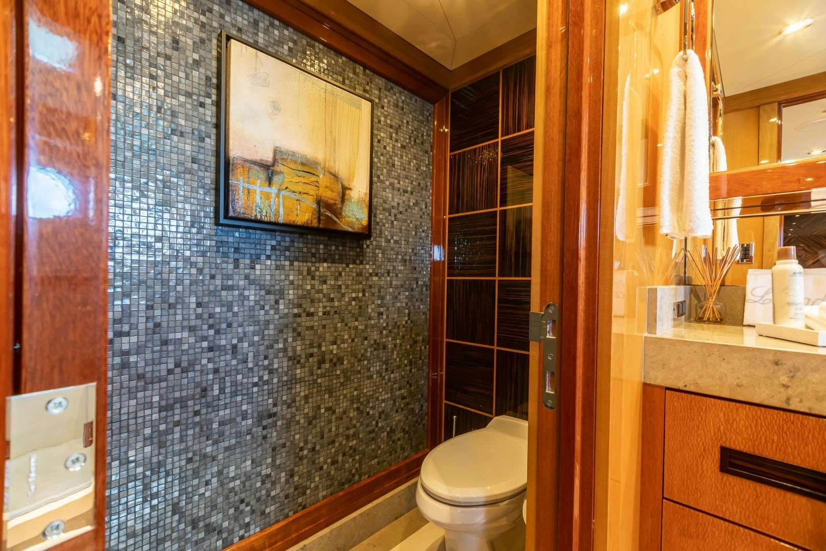 a bathroom with a blue tiled wall aboard IMPROMPTU Yacht for Sale