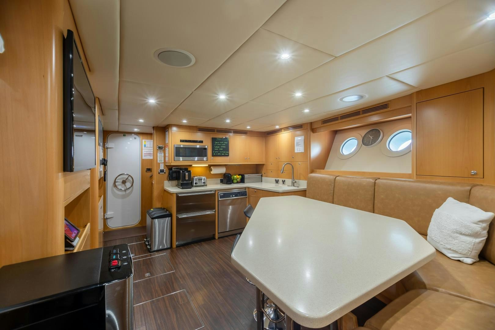 a large kitchen with a large round table aboard IMPROMPTU Yacht for Sale
