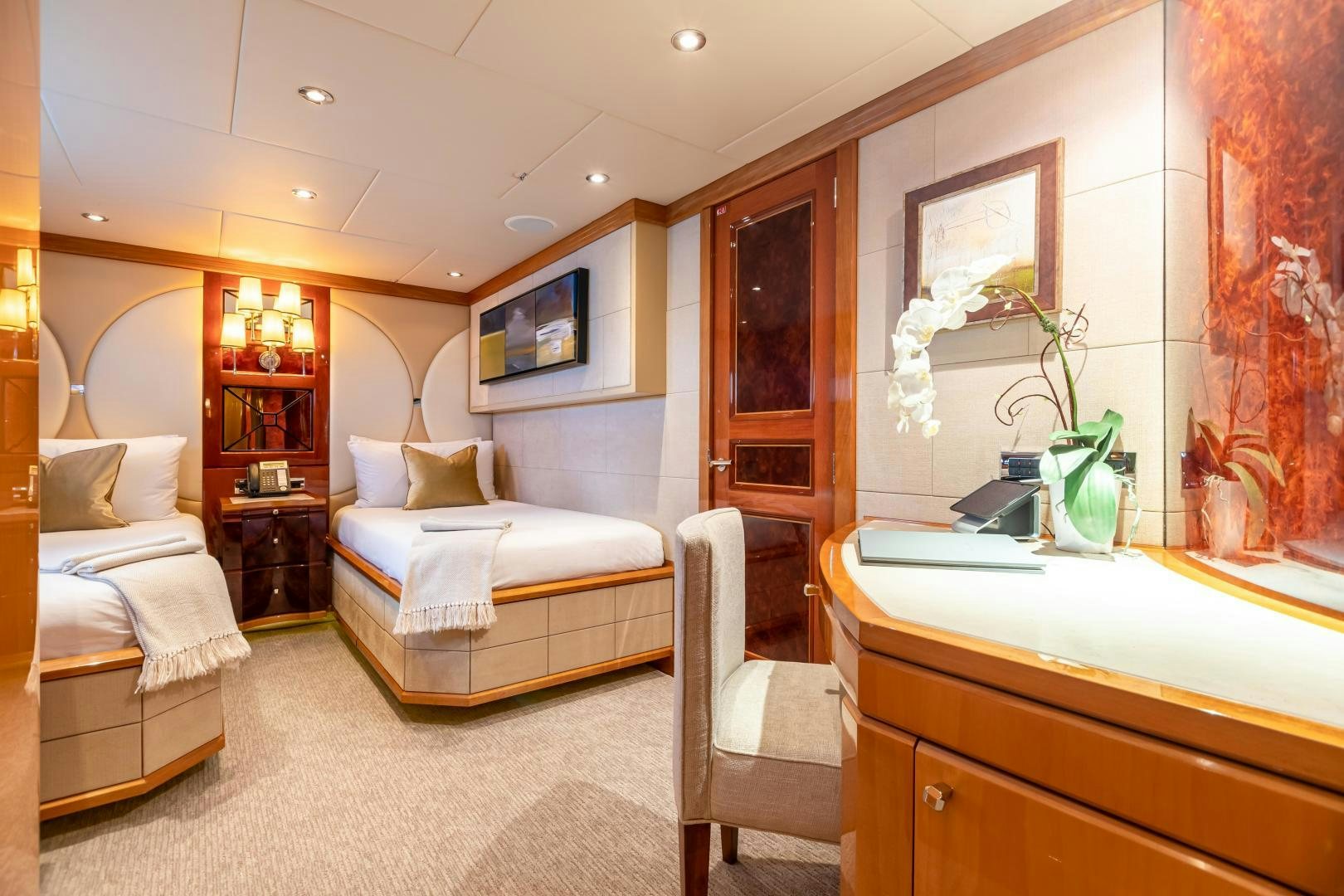 a room with a bed and a desk aboard IMPROMPTU Yacht for Sale