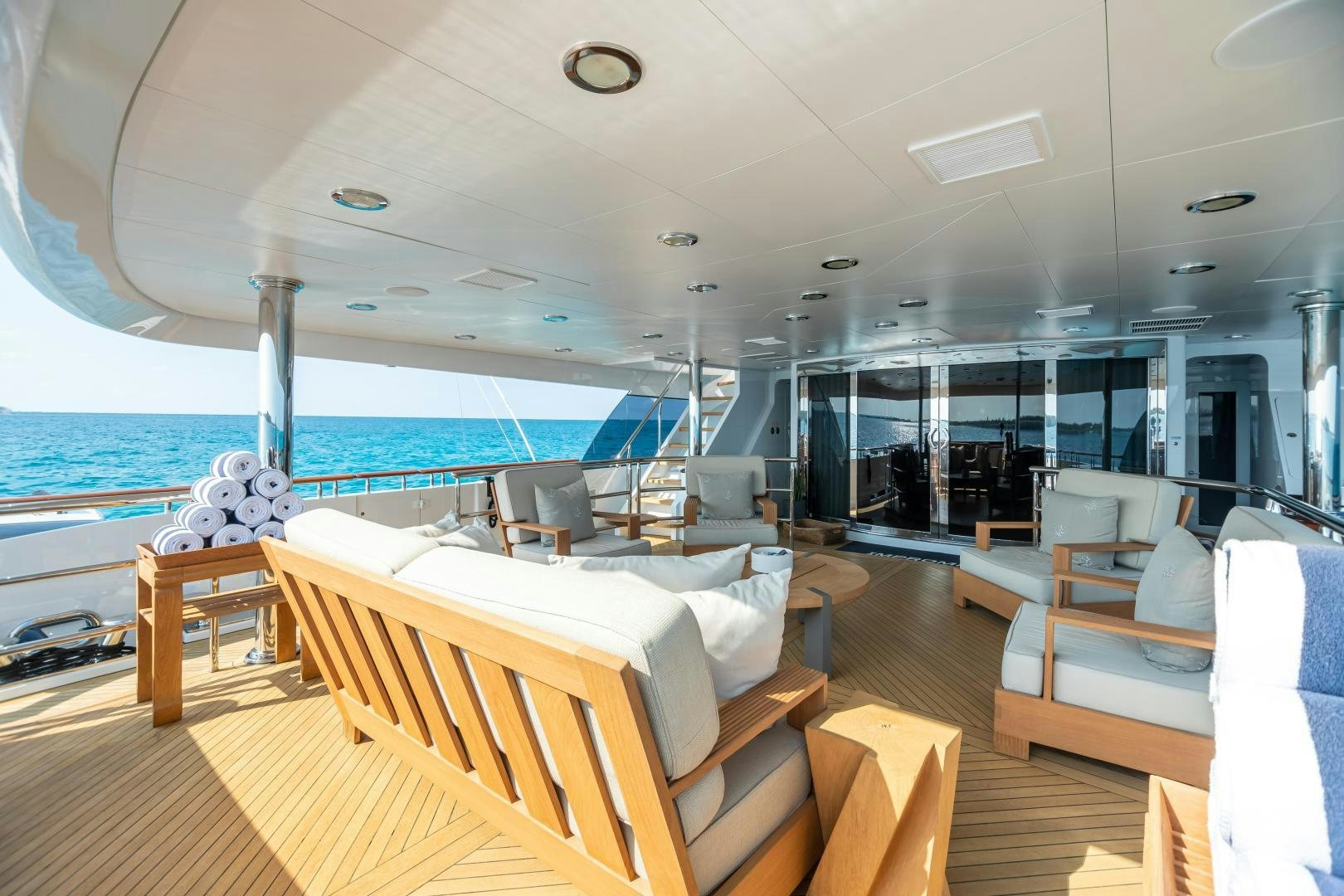 a room with a view of the ocean and the deck aboard IMPROMPTU Yacht for Charter