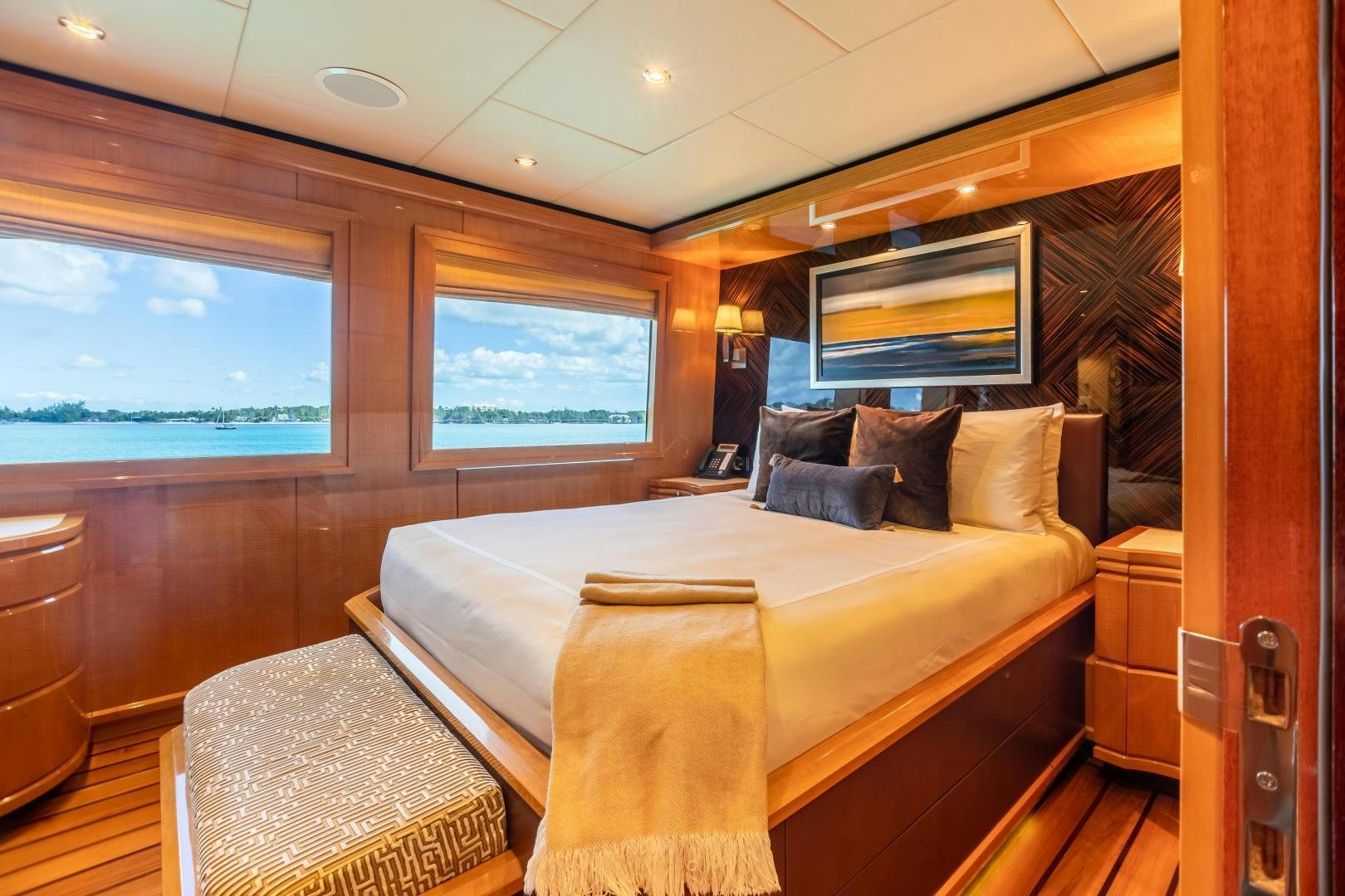 a bedroom with a bed and a chair aboard IMPROMPTU Yacht for Sale