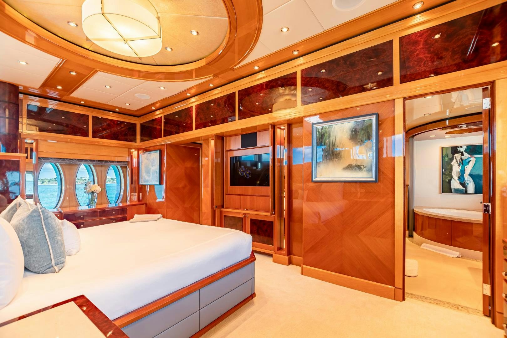 a room with a bed and a large mirror aboard IMPROMPTU Yacht for Sale