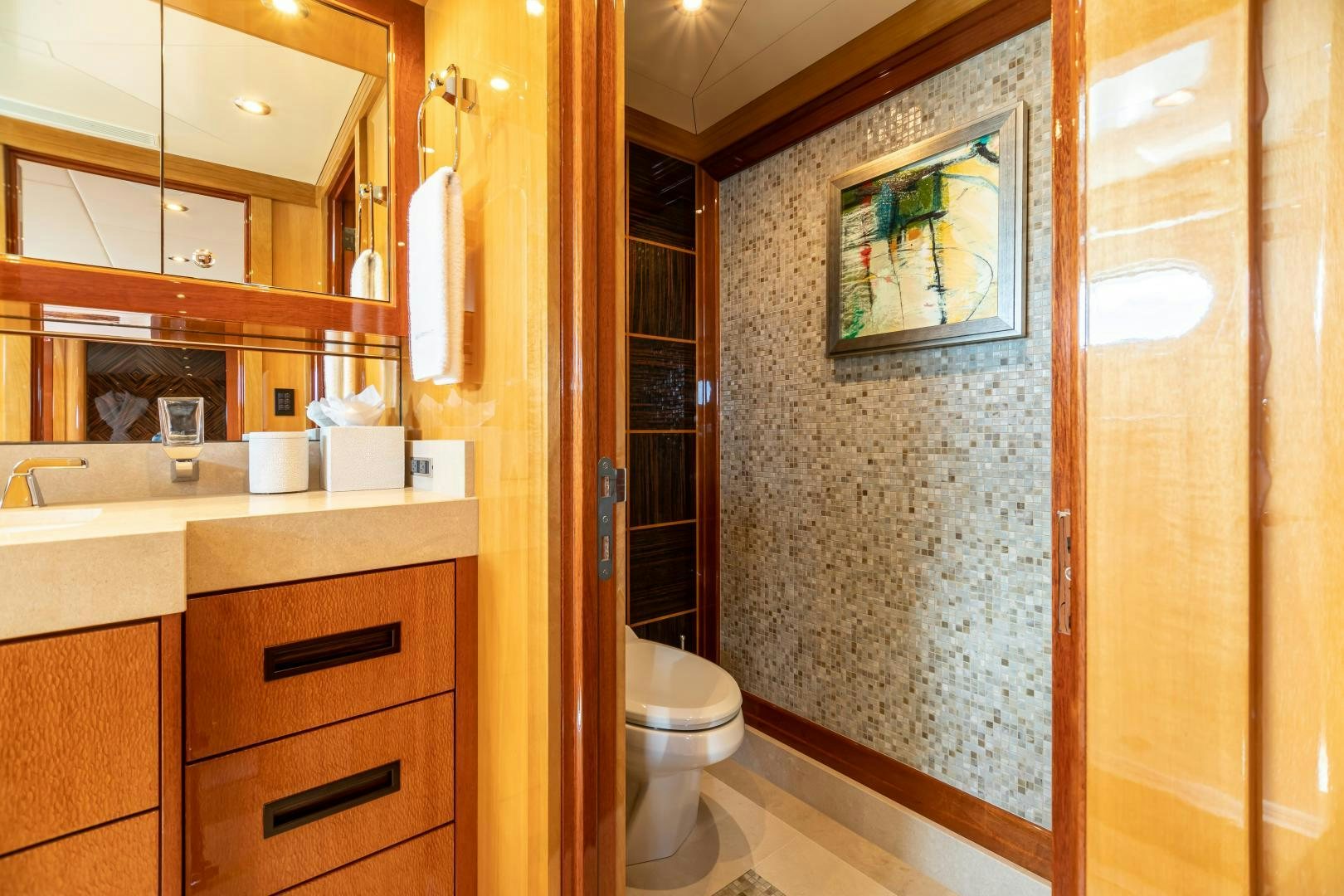 a bathroom with a toilet and sink aboard IMPROMPTU Yacht for Sale