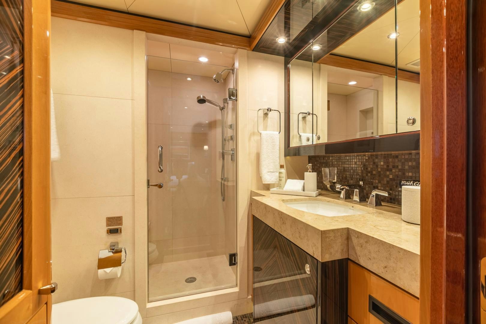 a bathroom with a glass shower aboard IMPROMPTU Yacht for Charter