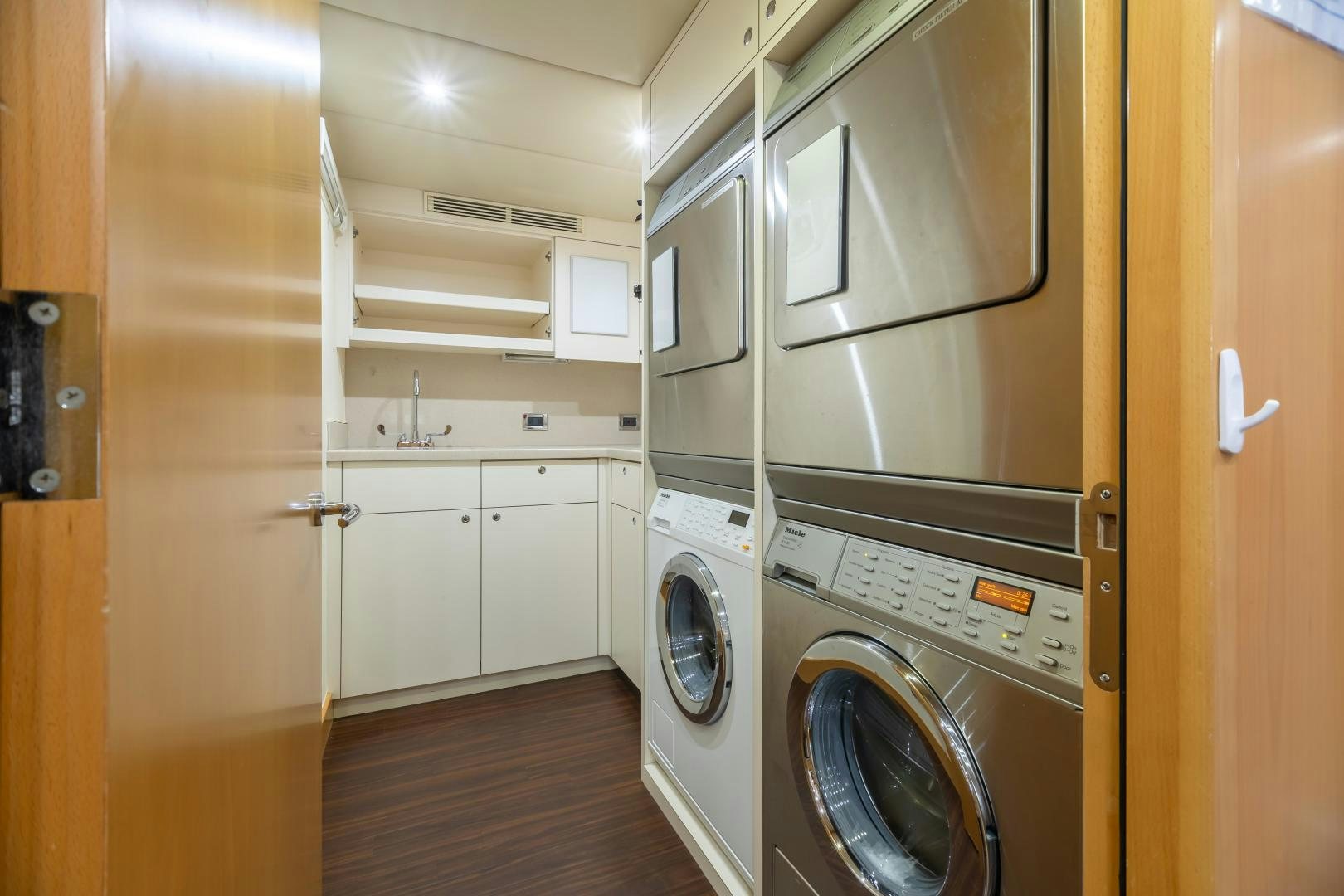a laundry room with a washer and dryer aboard IMPROMPTU Yacht for Sale