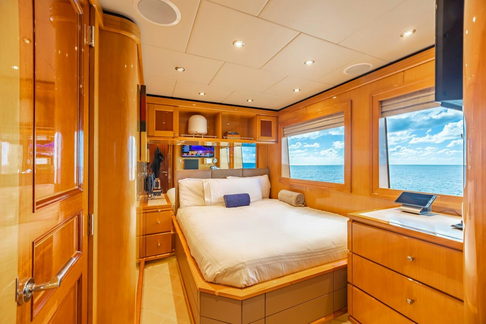 a bedroom with a bed and a closet aboard IMPROMPTU Yacht for Sale