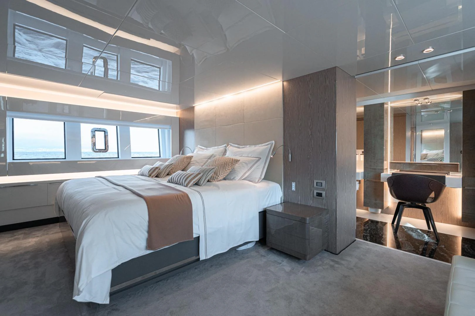 a bedroom with a bed and a desk aboard MOTEK Yacht for Sale