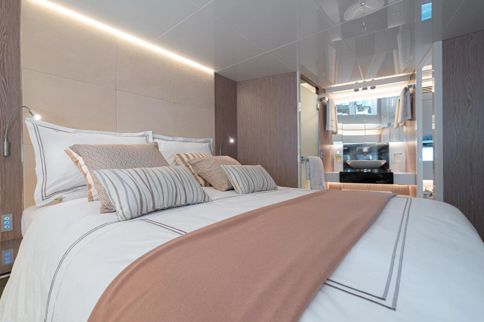 a bed with a white sheet and pillows aboard MOTEK Yacht for Sale