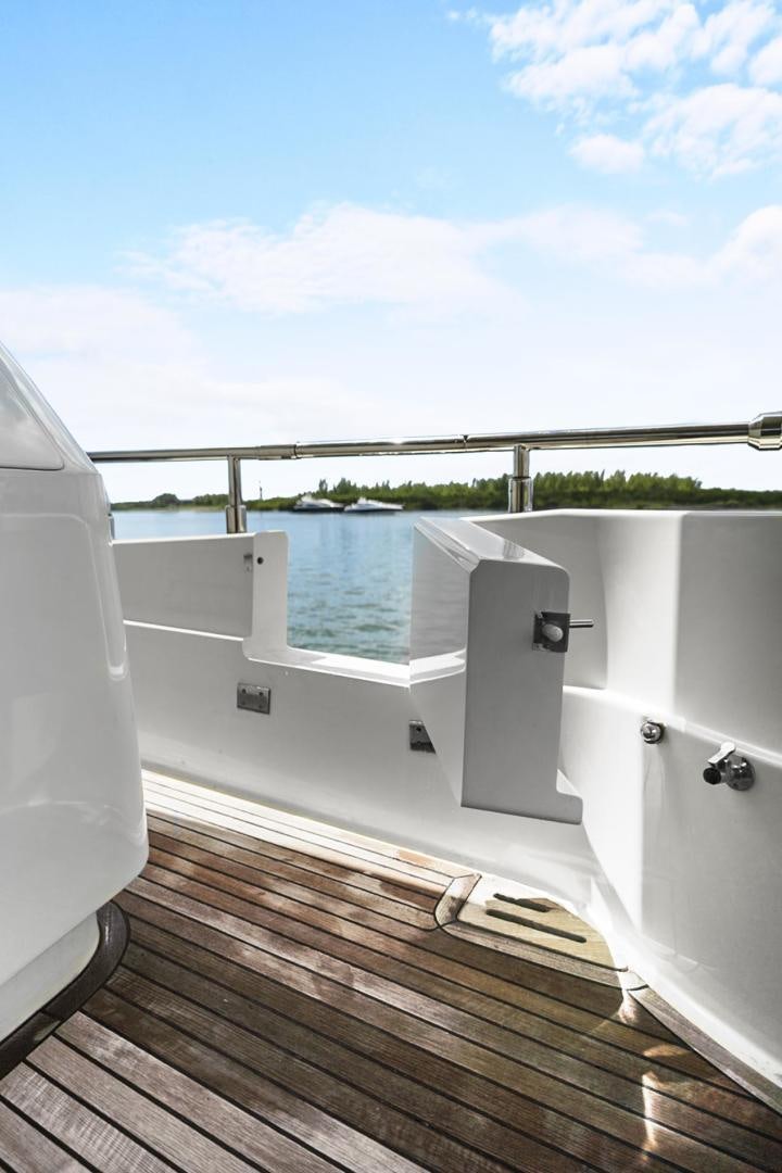 a white bathtub with a wooden floor and a wood deck overlooking a lake aboard EL PATRON Yacht for Sale