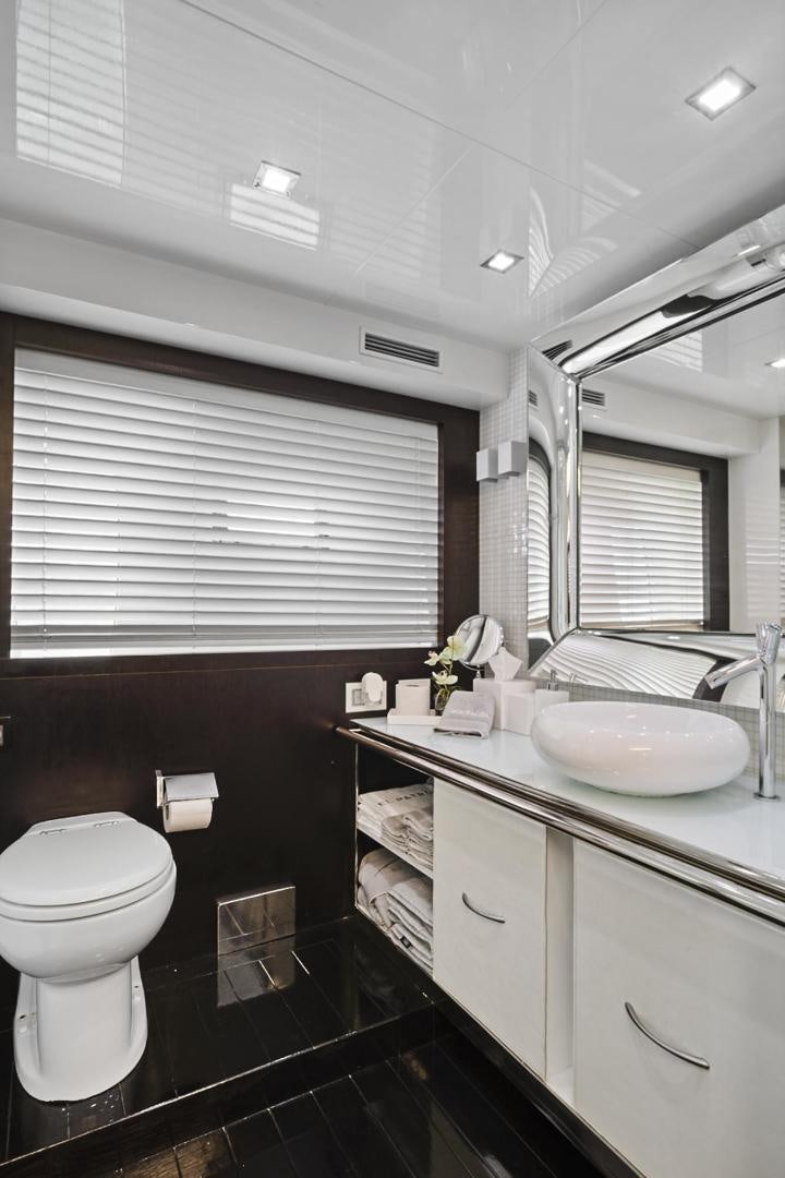 a bathroom with a sink toilet and a mirror aboard EL PATRON Yacht for Sale