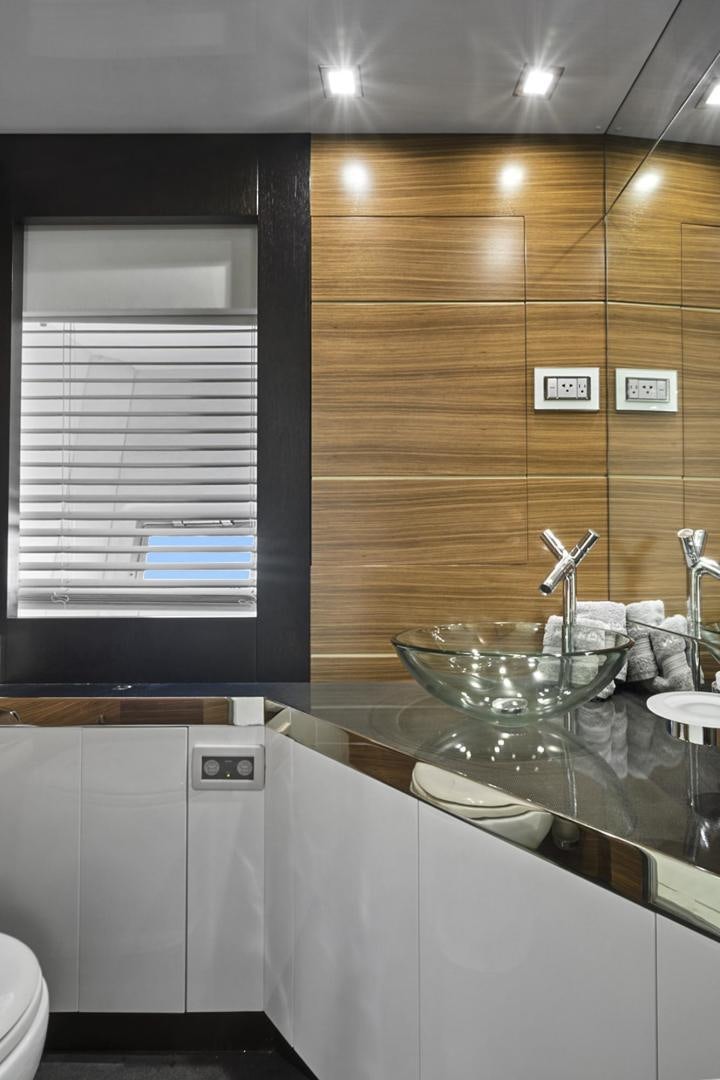 a bathroom with a glass bowl aboard EL PATRON Yacht for Sale