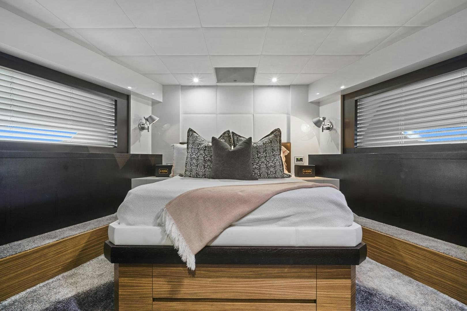 a room with a bed and a window aboard EL PATRON Yacht for Sale