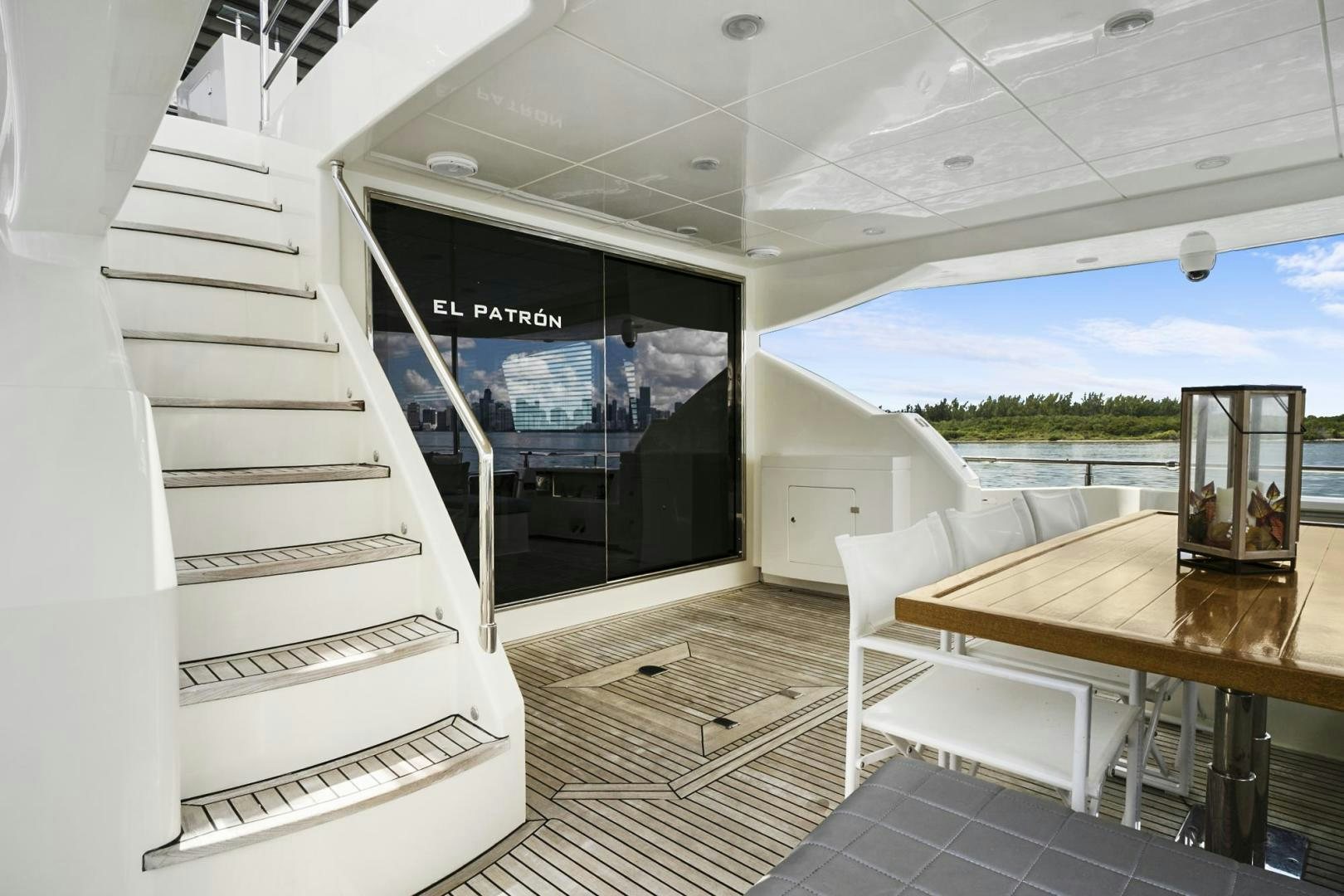 a room with a table and chairs aboard EL PATRON Yacht for Sale