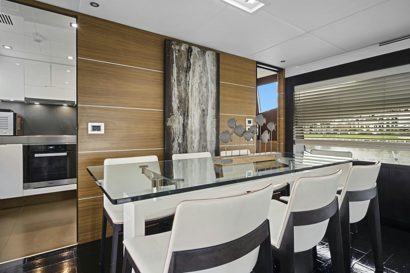 a room with tables and chairs aboard EL PATRON Yacht for Sale