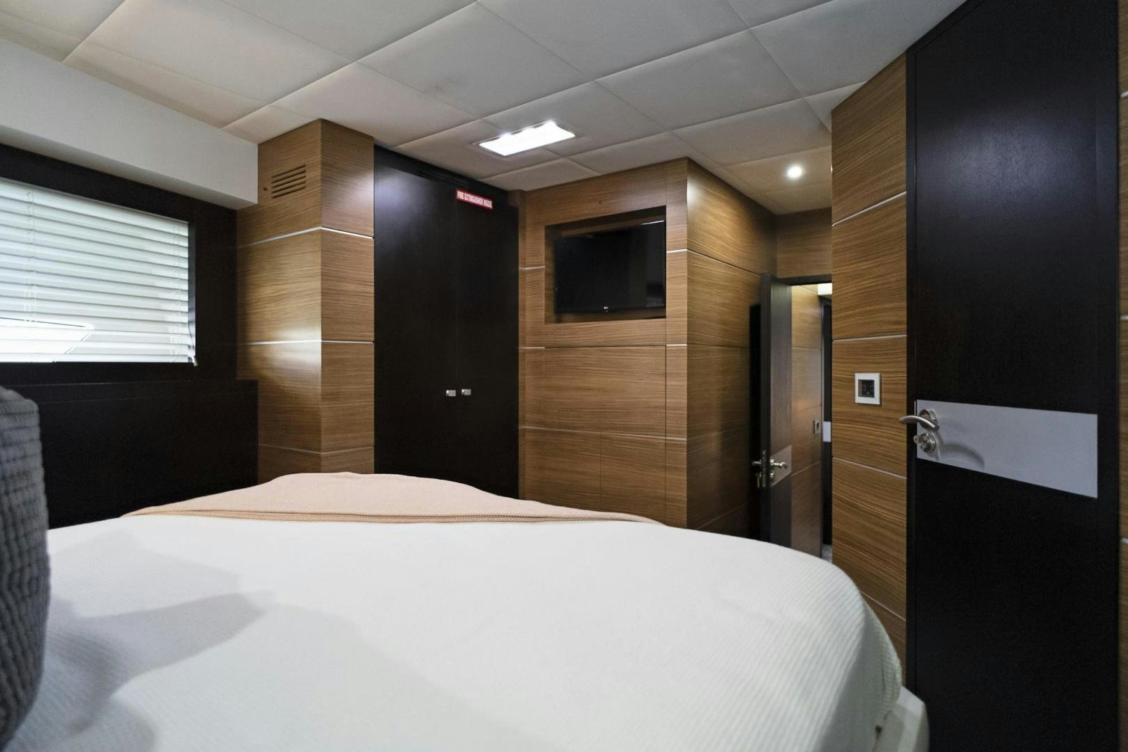a room with a bed and a closet aboard EL PATRON Yacht for Sale