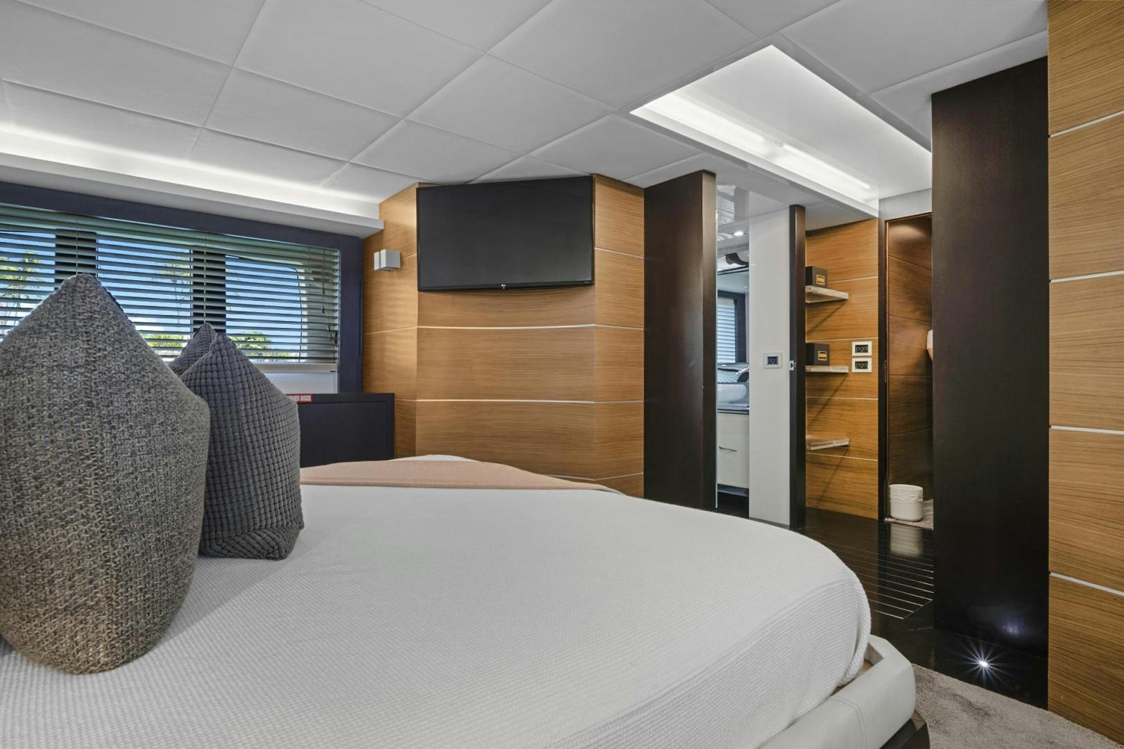 a room with a bed and a large mirror aboard EL PATRON Yacht for Sale