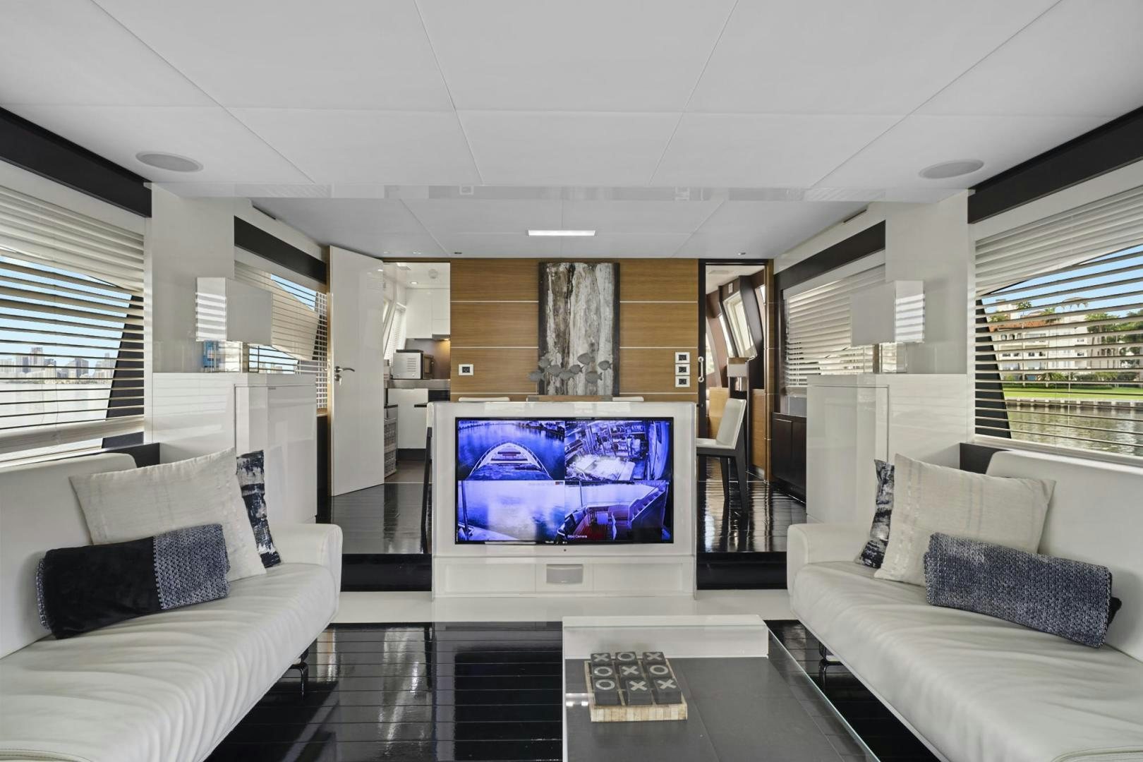 a living room with a large screen aboard EL PATRON Yacht for Sale
