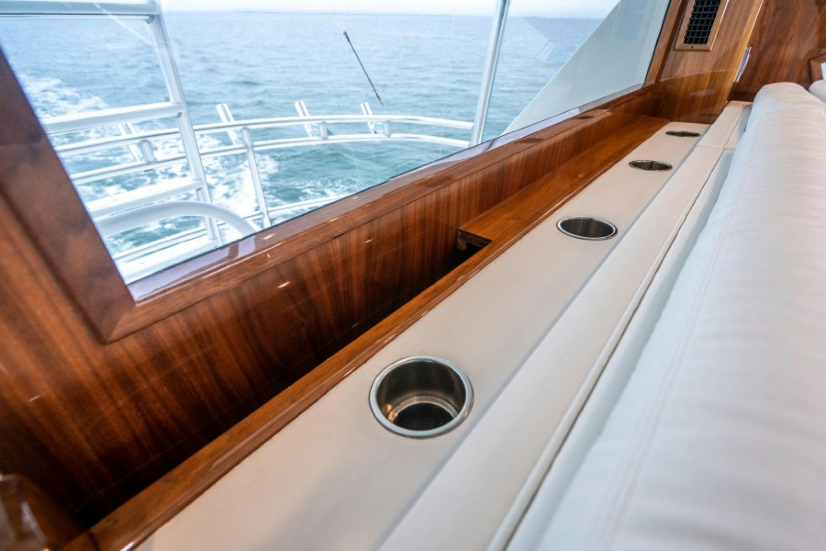 a wooden table with a round metal object on it aboard TIKI BAR Yacht for Sale