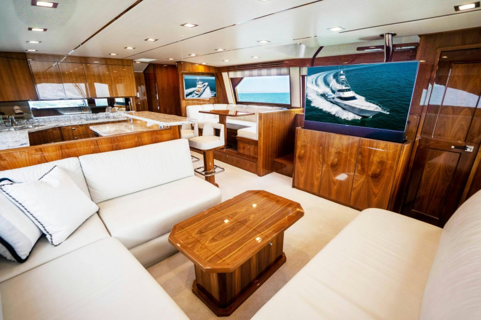 a room with a large window and a table with chairs aboard TIKI BAR Yacht for Sale