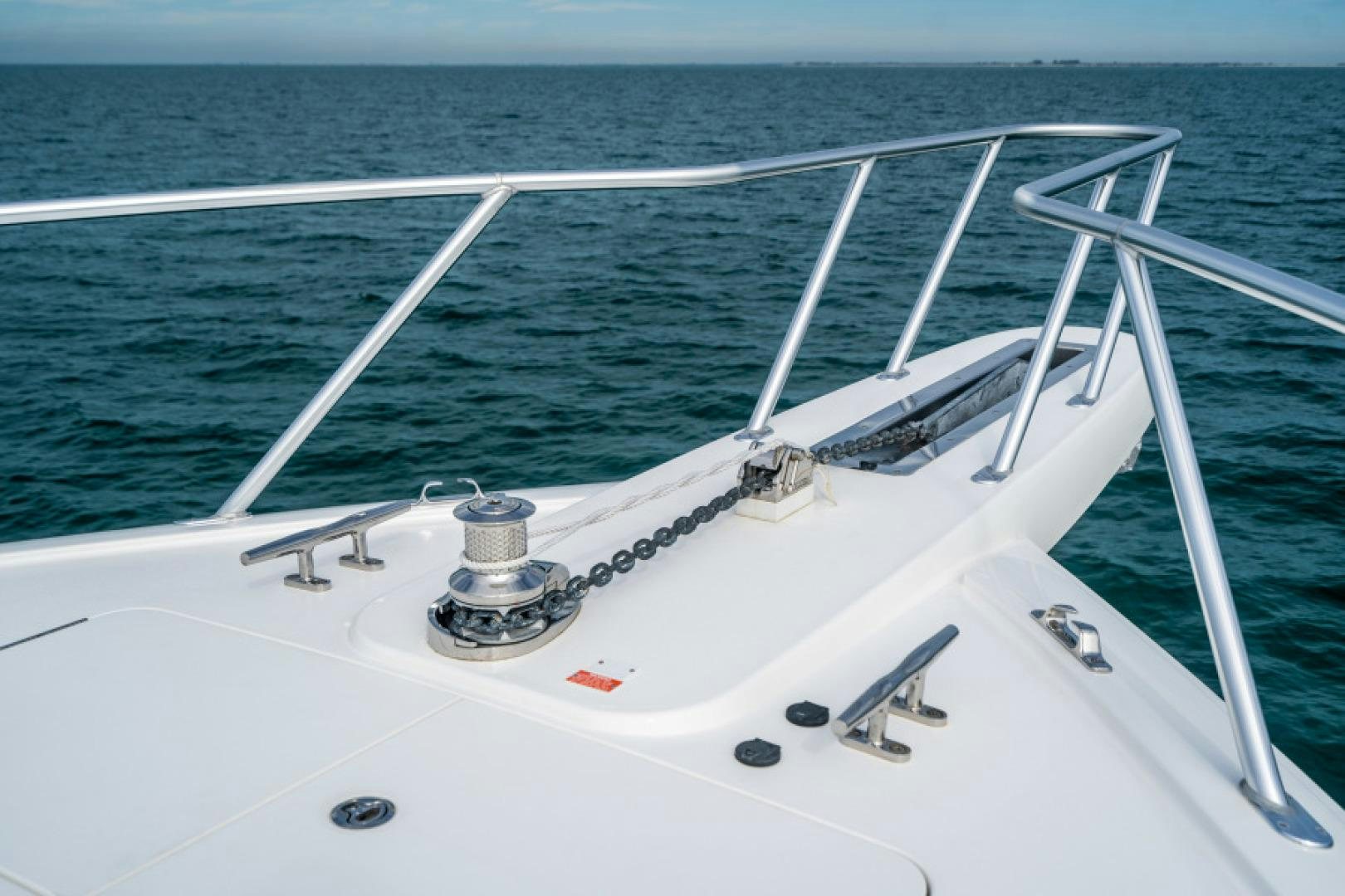 a white boat on the water aboard TIKI BAR Yacht for Sale