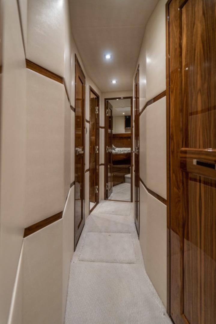 a hallway with a staircase and doors aboard TIKI BAR Yacht for Sale