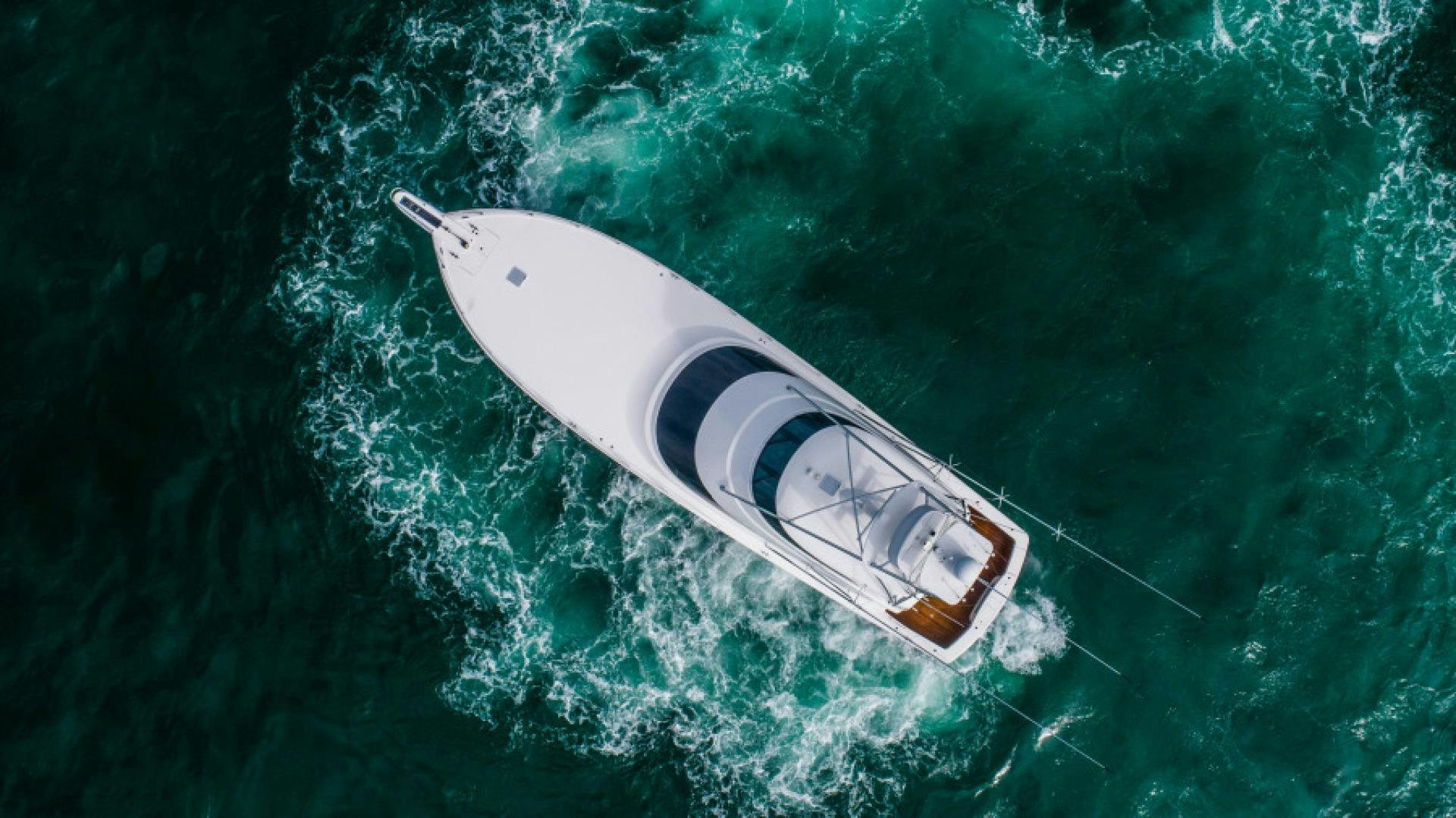 a white and black boat in the water aboard TIKI BAR Yacht for Sale