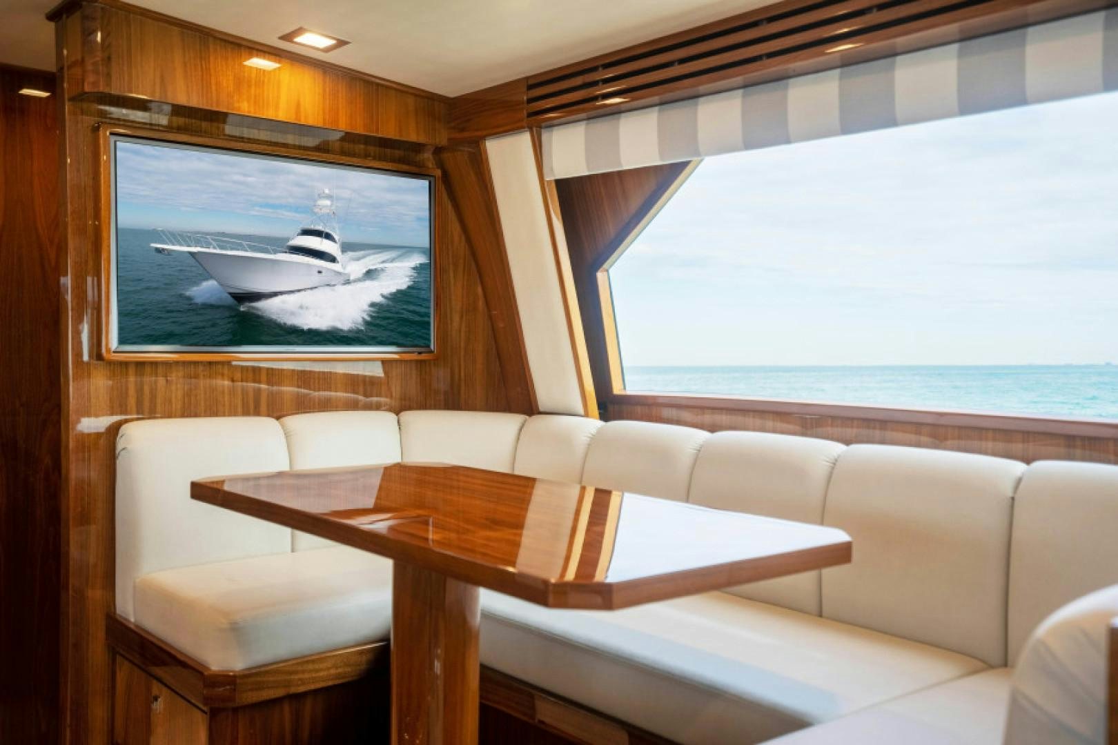 a room with a table and chairs and a plane in the sky aboard TIKI BAR Yacht for Sale