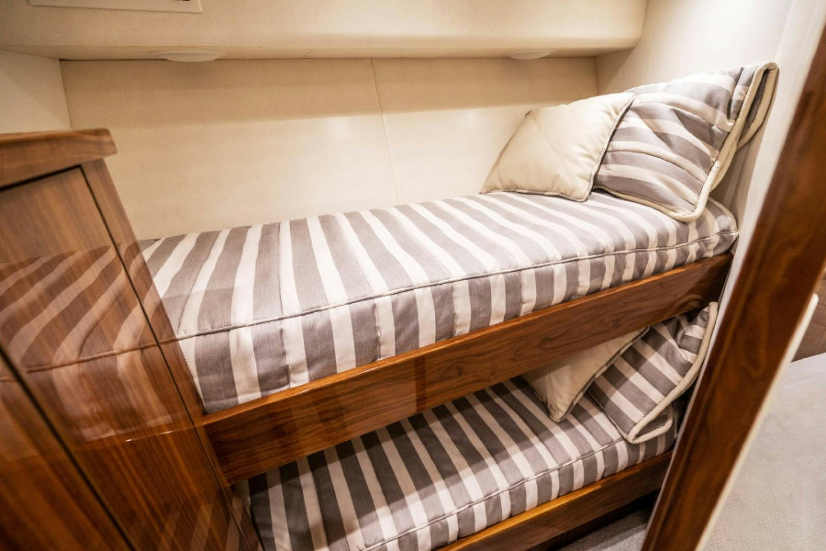 a bed with a striped sheet aboard TIKI BAR Yacht for Sale