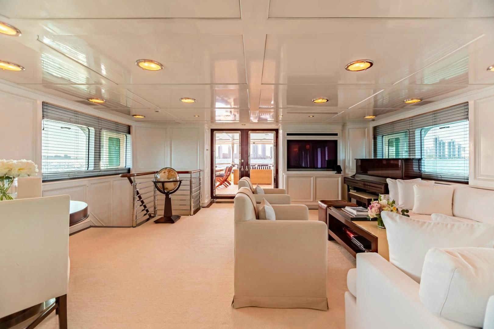 a living room with white furniture aboard EXPLORA Yacht for Sale