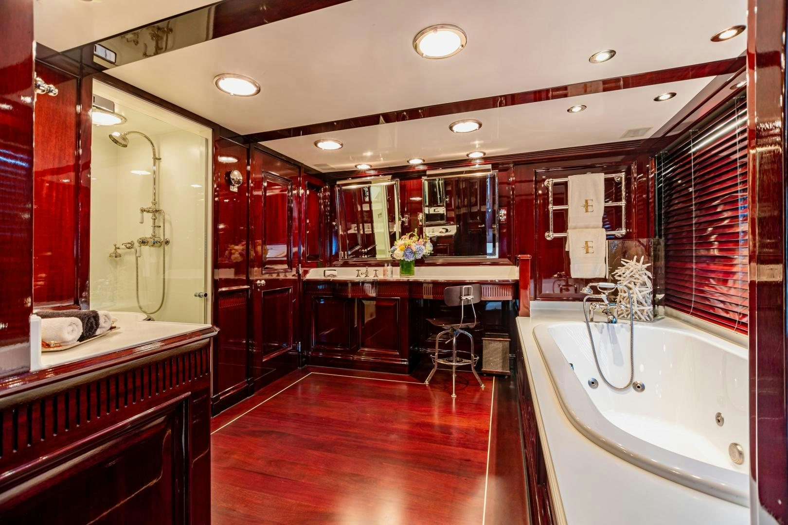 a bathroom with a tub and sink aboard EXPLORA Yacht for Sale