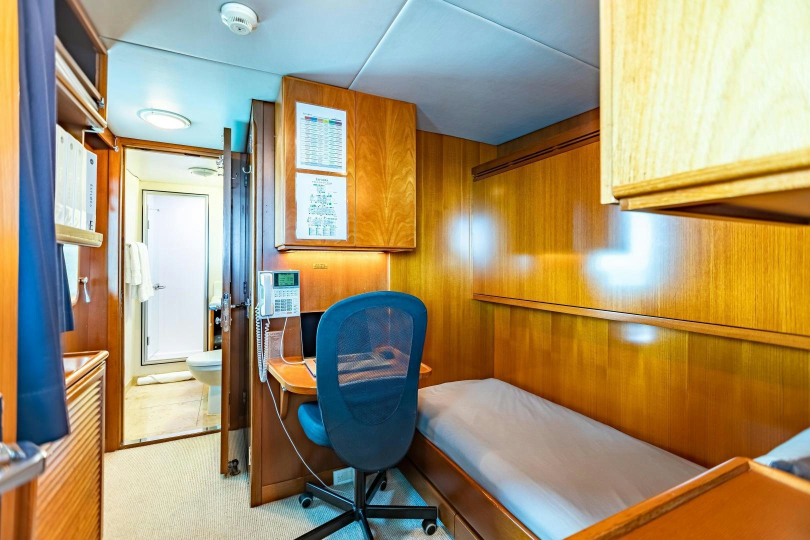 a hospital room with a bed and desk aboard EXPLORA Yacht for Sale