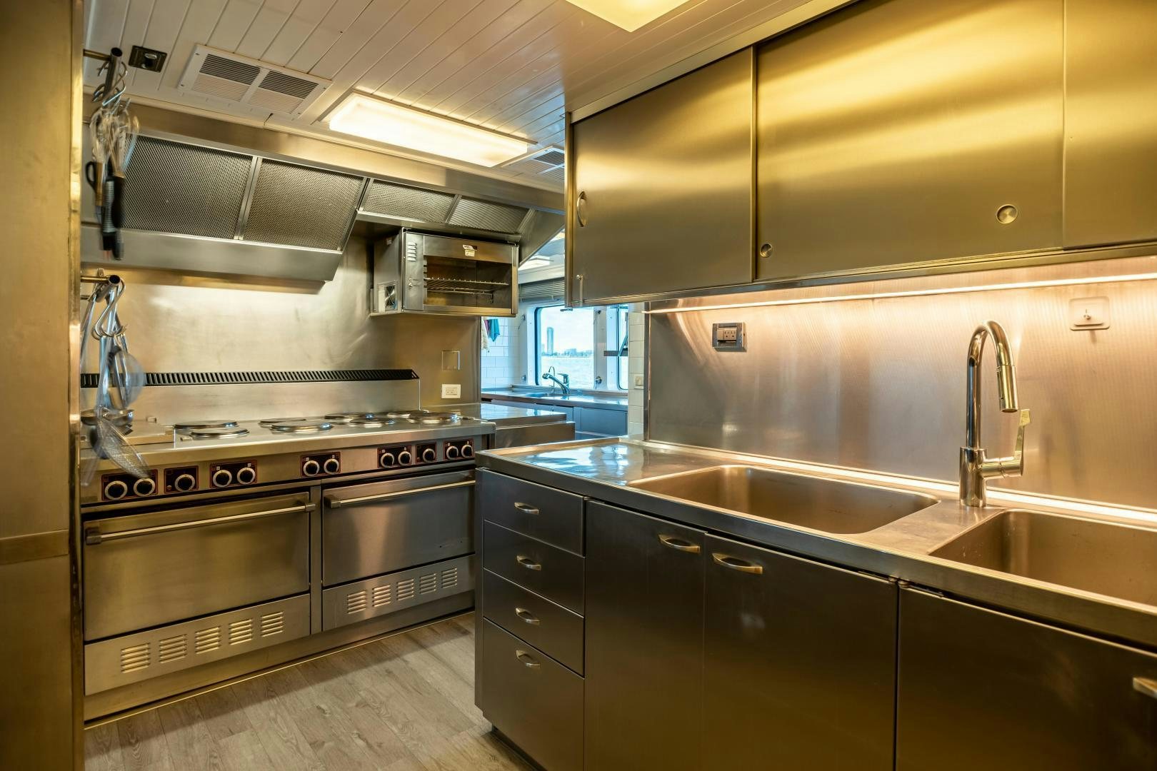 a kitchen with stainless steel appliances aboard EXPLORA Yacht for Sale