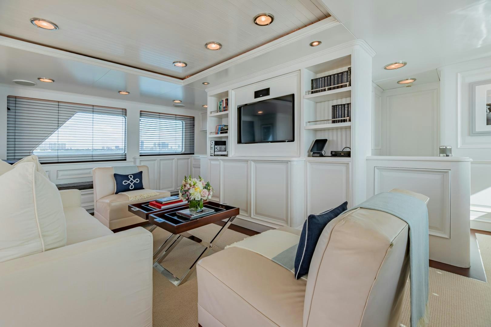 a living room with a couch and a television aboard EXPLORA Yacht for Sale