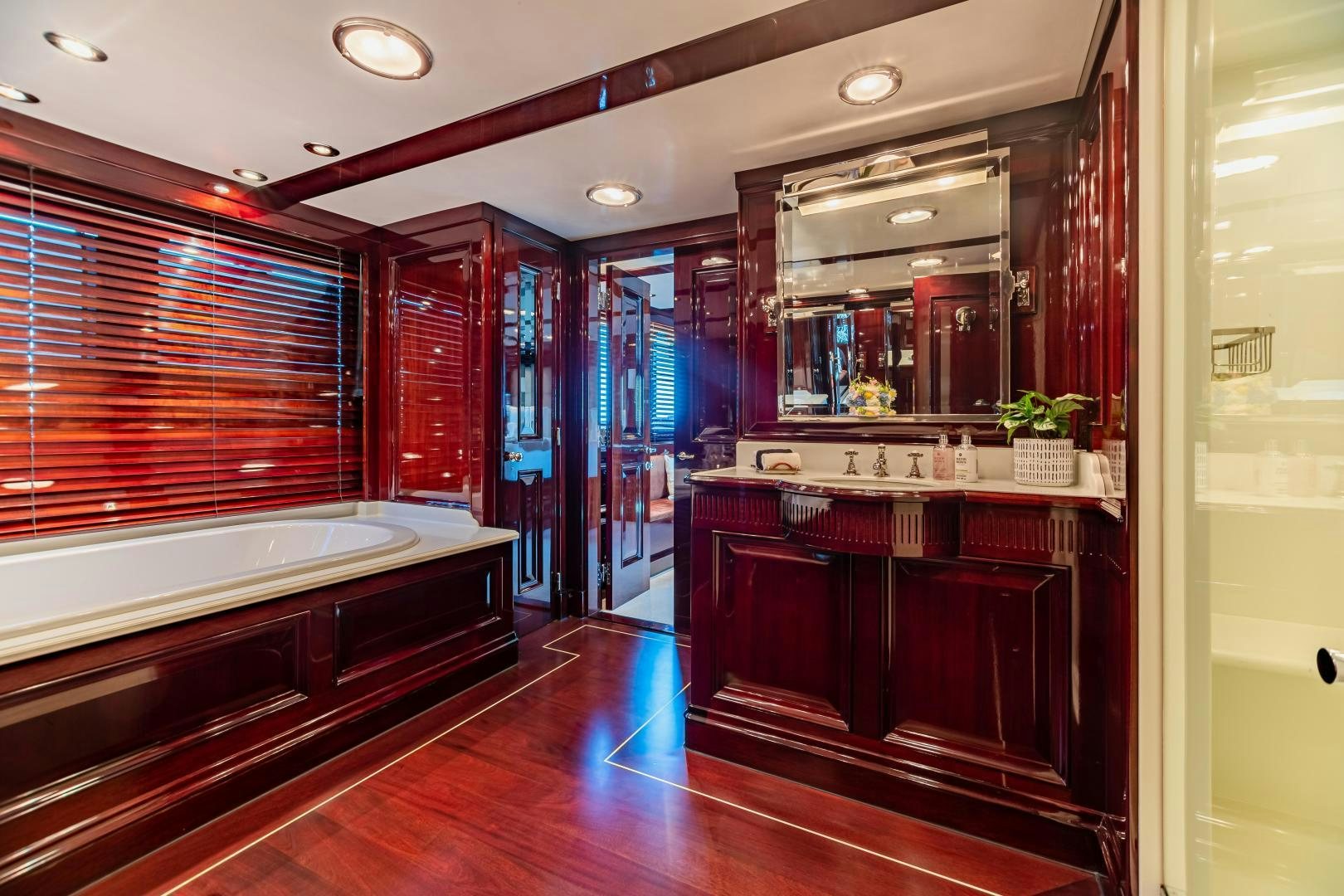 a bathroom with a tub and a sink aboard EXPLORA Yacht for Sale