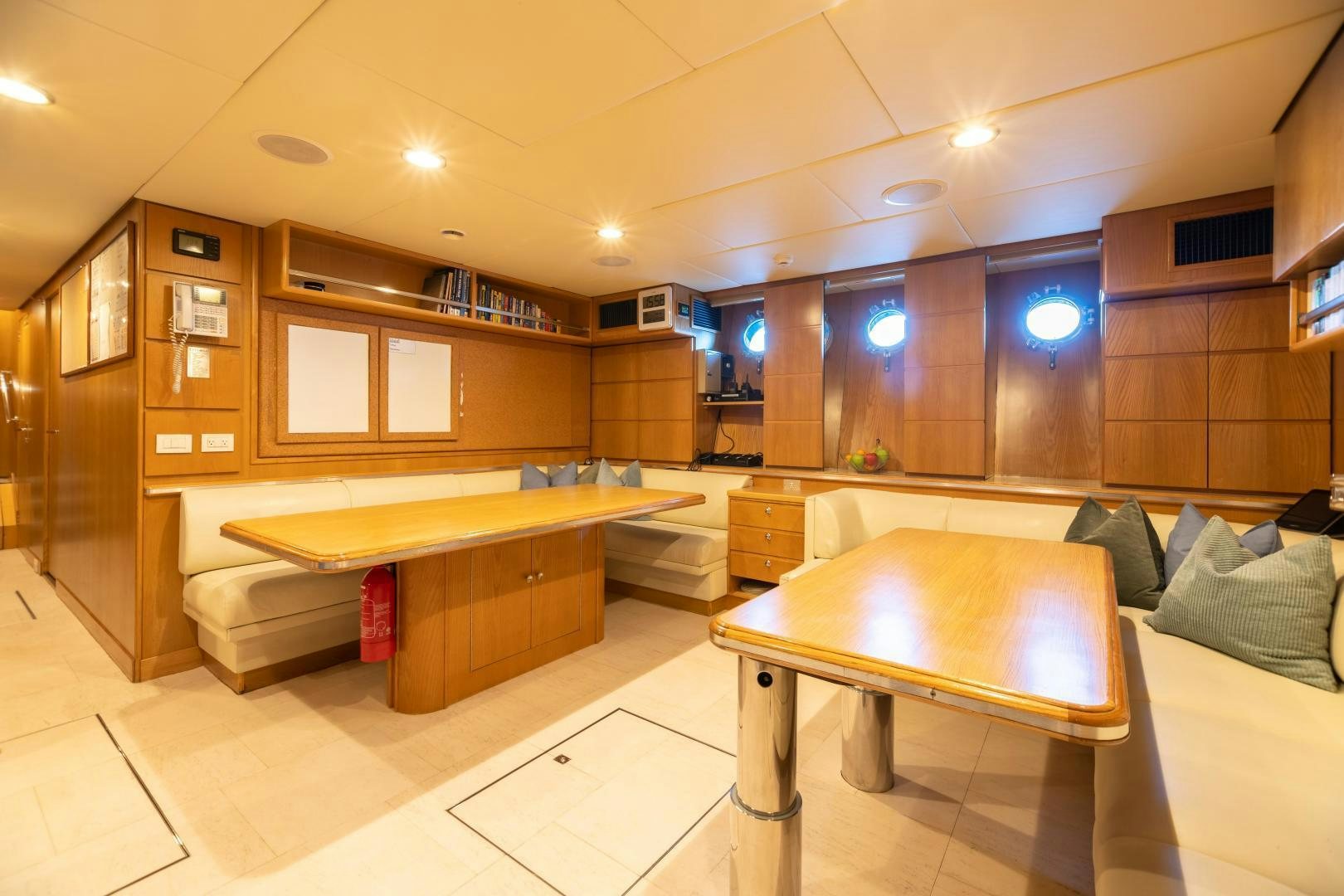 a room with a bed and a table aboard EXPLORA Yacht for Sale